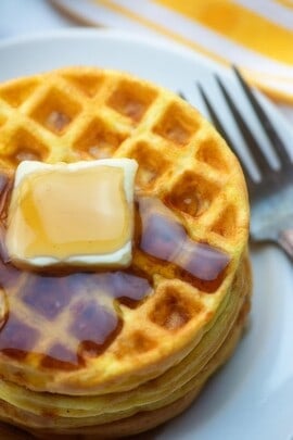 A plate of food with a fork, with Waffle