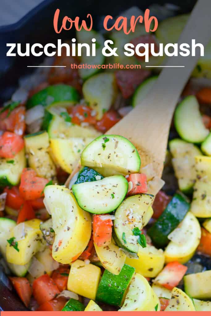 Squash and zucchini on wooden spoon in skillet.