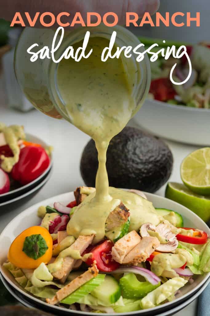 Avocado dressing being drizzled over salad.