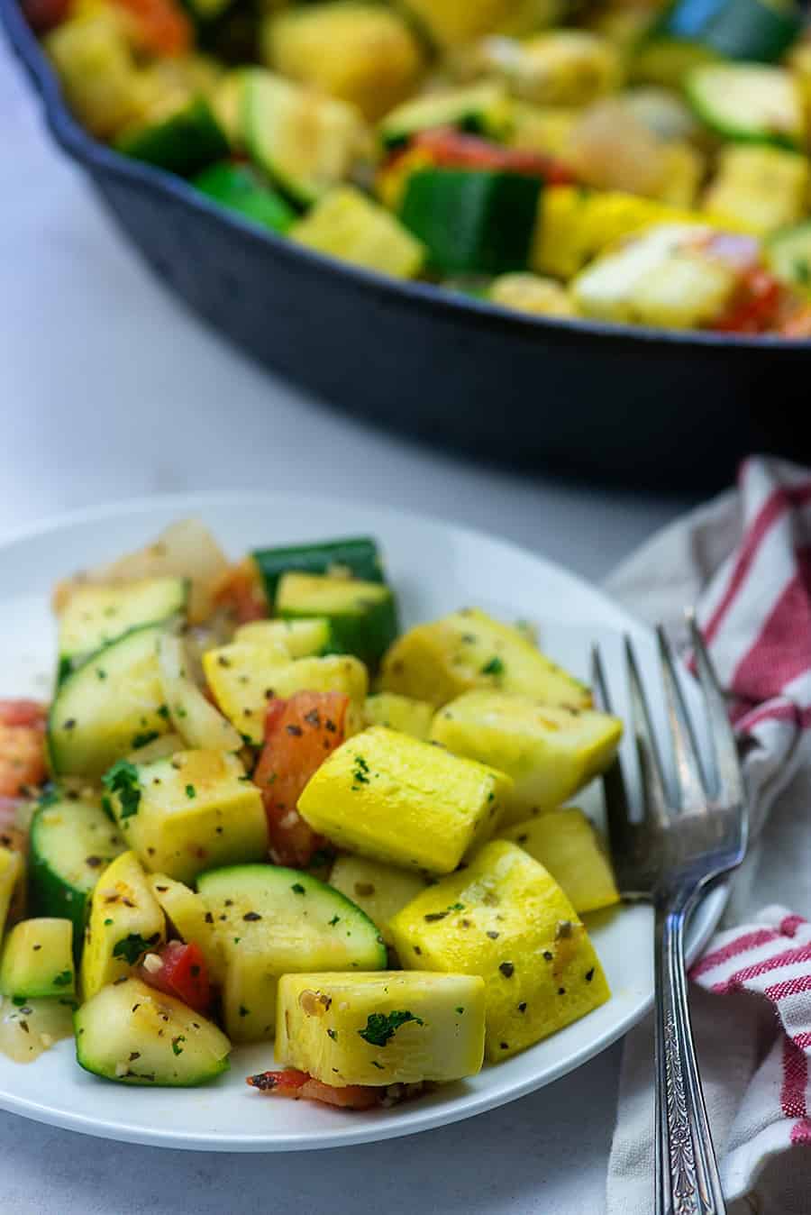 sauteed squash and zucchini on white plate