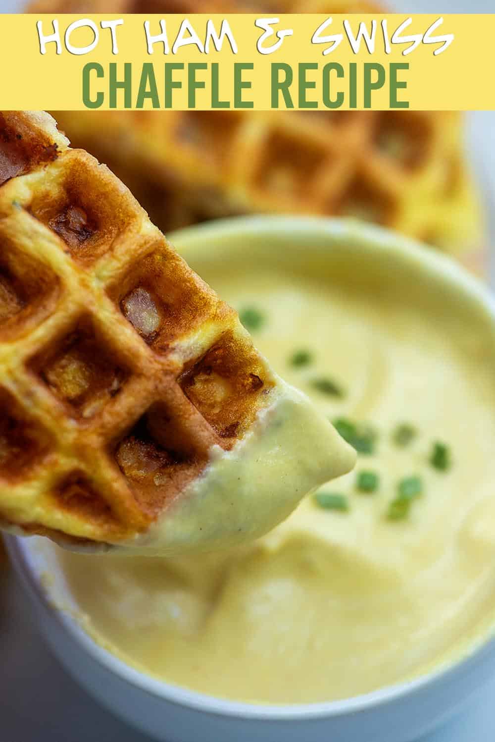 A close up of a chaffle being dipped into a cheese sauce