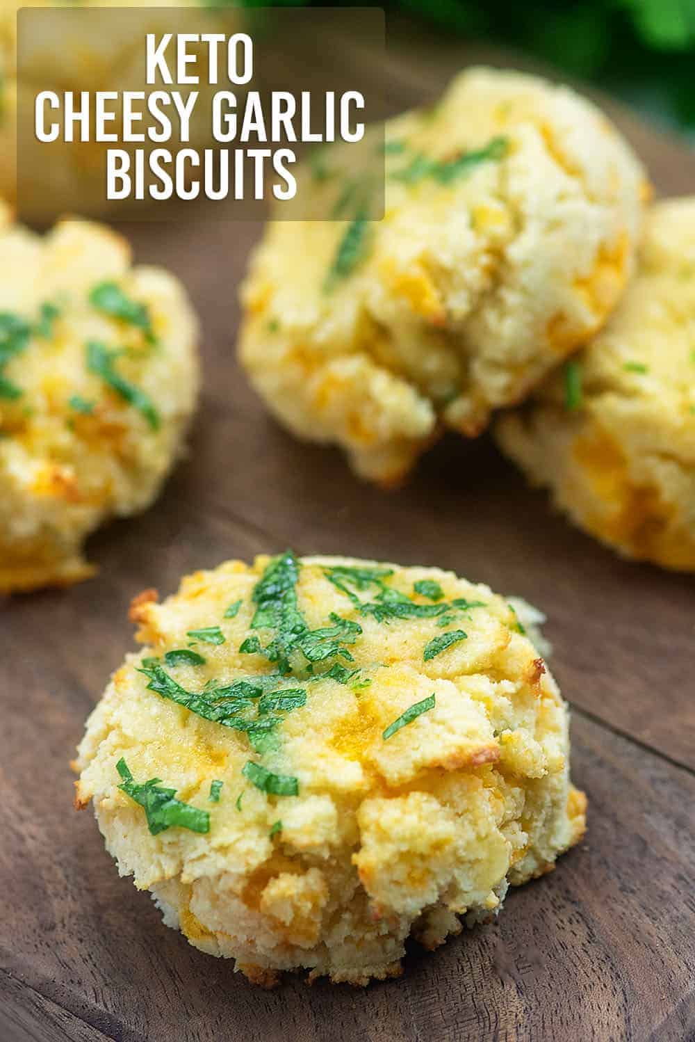 four cheddar biscuits on a cutting board