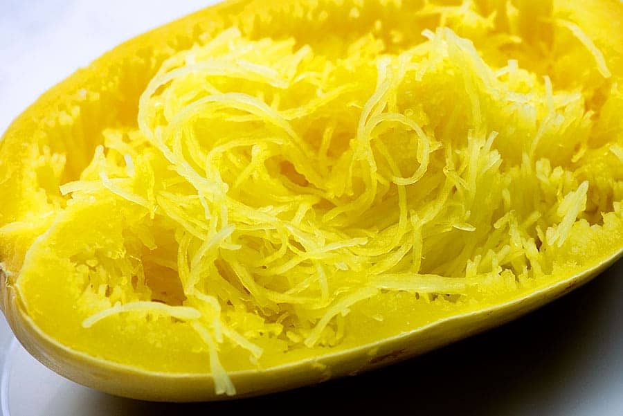 A close up of squash shredded like spaghetti noodles.