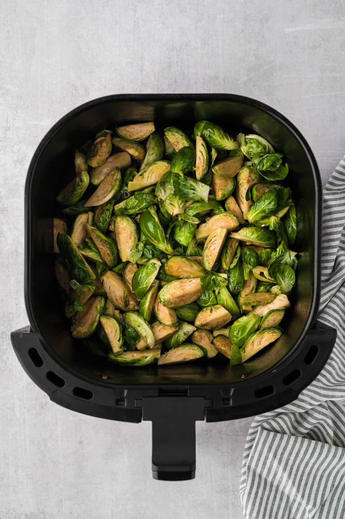 Brussels sprouts in air fryer basket.