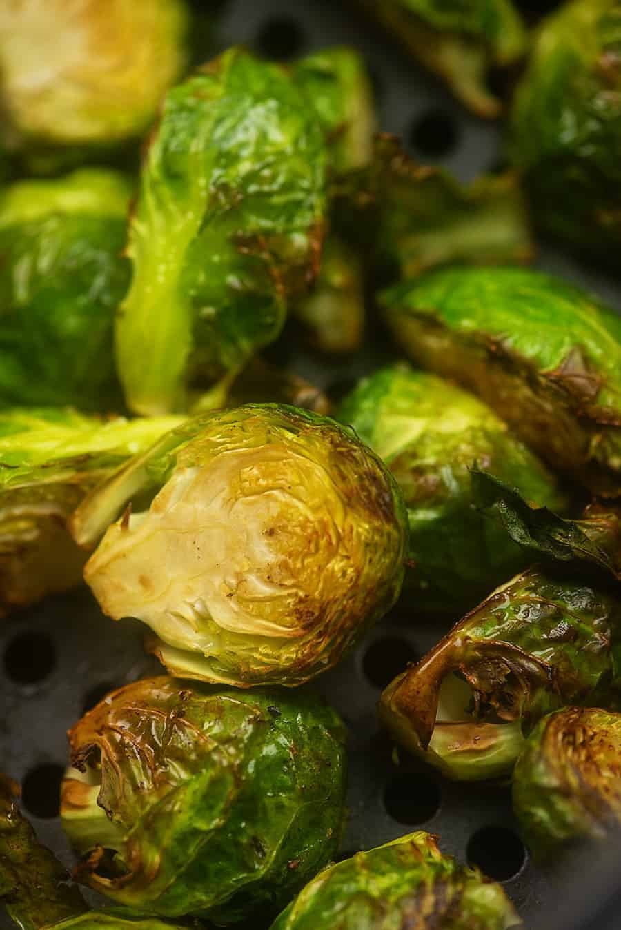 cooked brussel sprouts on an air fryer pan