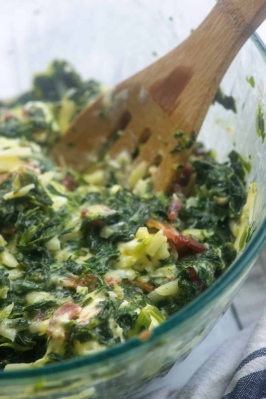 spinach casserole ingredients in a glass bowl