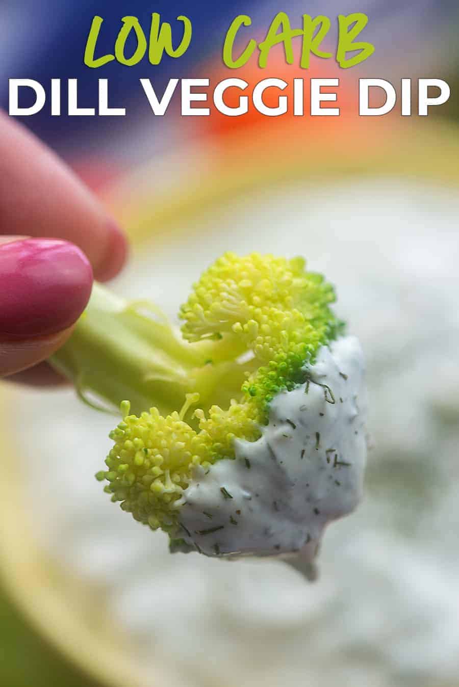 A close up of a woman holding a piece of broccoli that has been dipped.