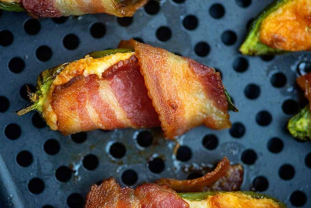 baked jalapeno poppers with bacon on an air fryer pan