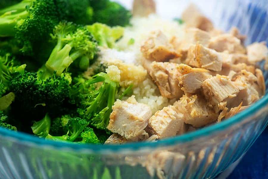 ingredients for chicken broccoli alfredo bake in a glass bowl