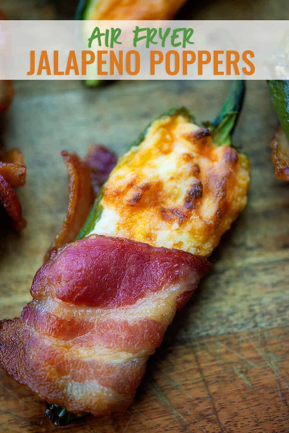 Air Fryer Jalapeno Poppers wrapped in bacon on a cutting board