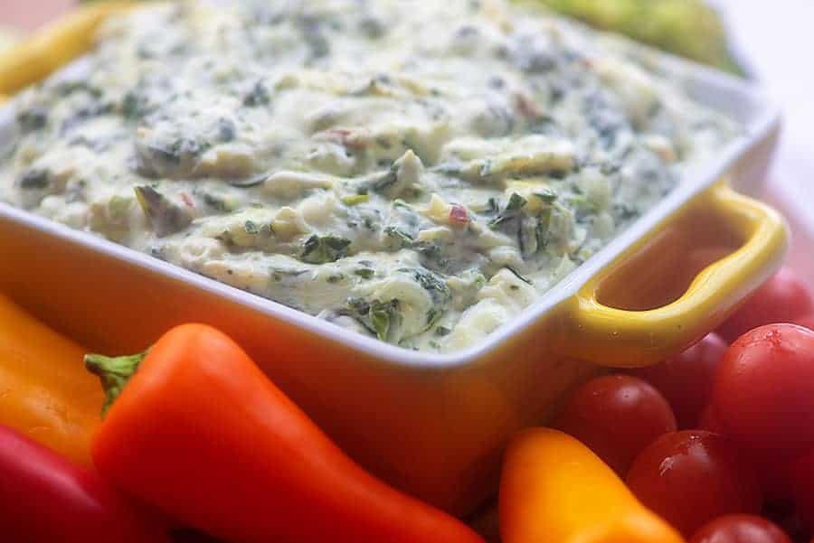 keto spinach dip in yellow bowl with vegetables