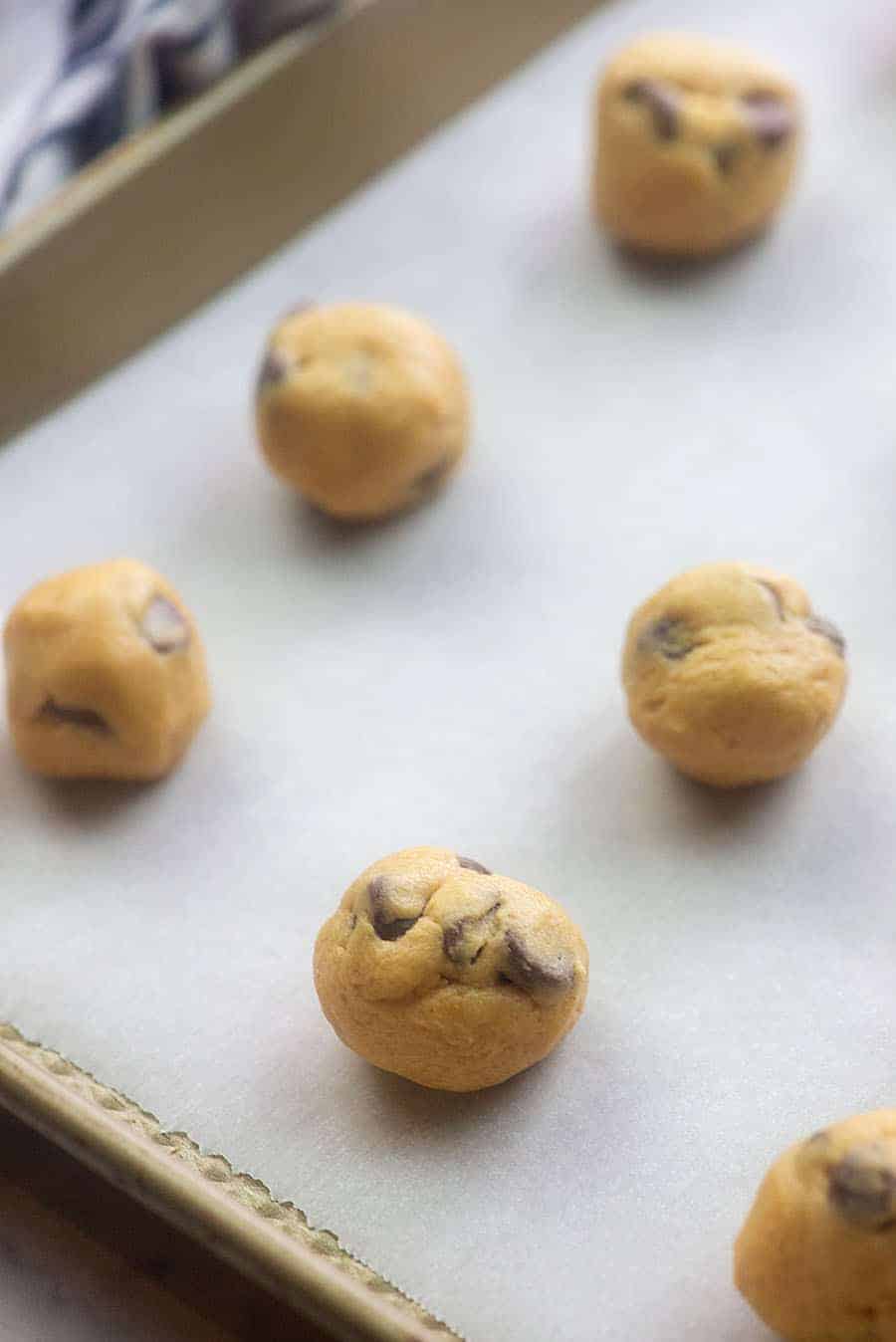 peanut butter fat bomb balls rolled up on a cookie sheet