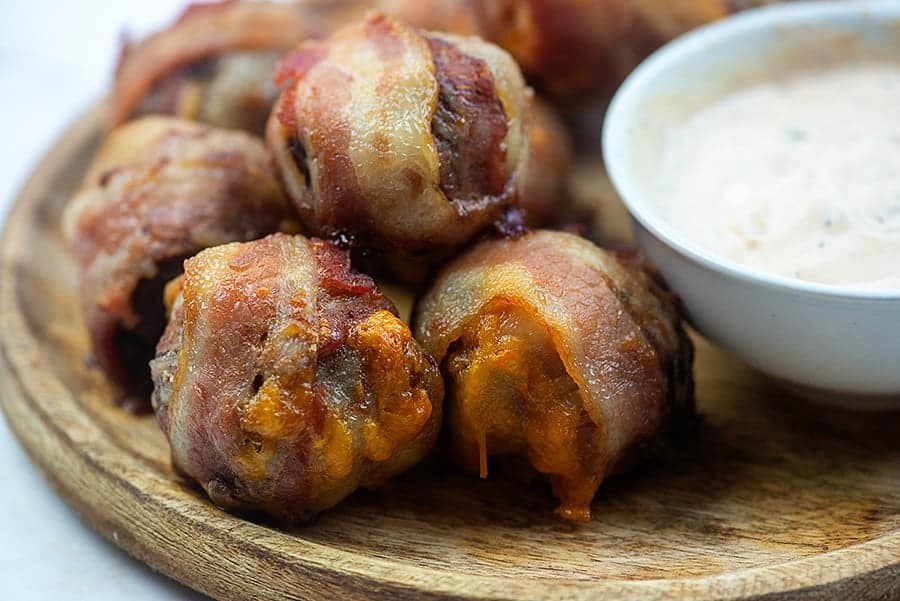 cheeseburger bacon bombs on a wooden tray