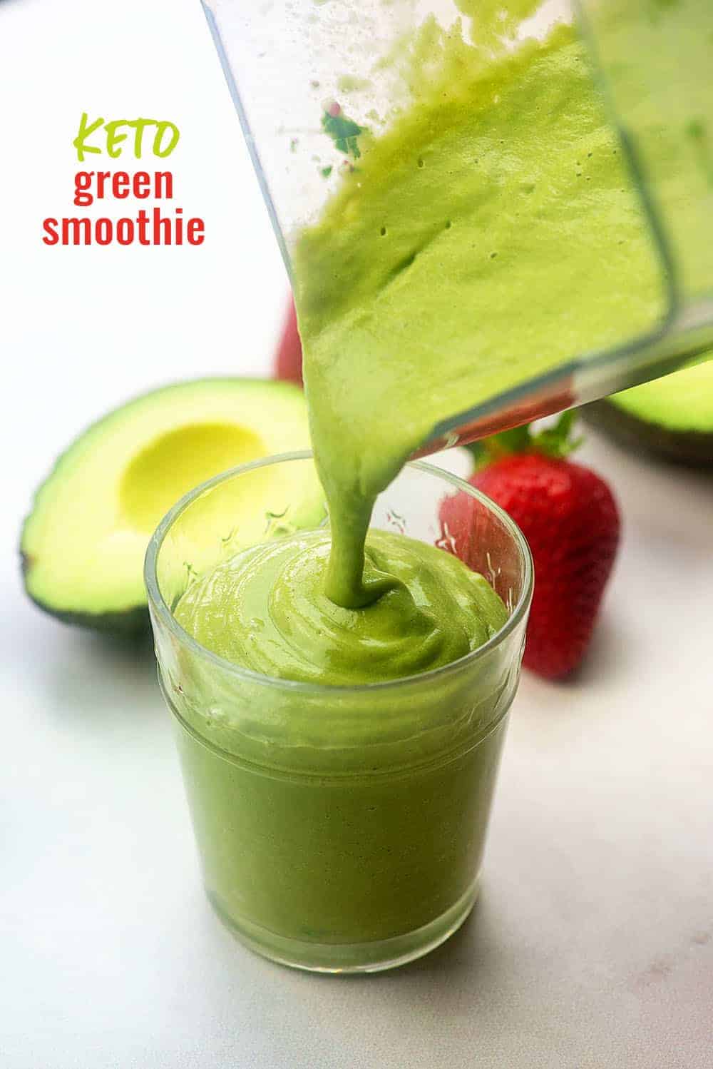 Pouring green smoothie from the blender into a glass