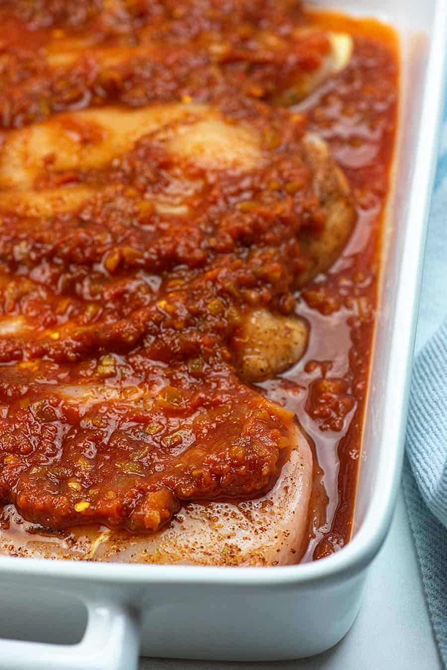 chicken with salsa in baking dish