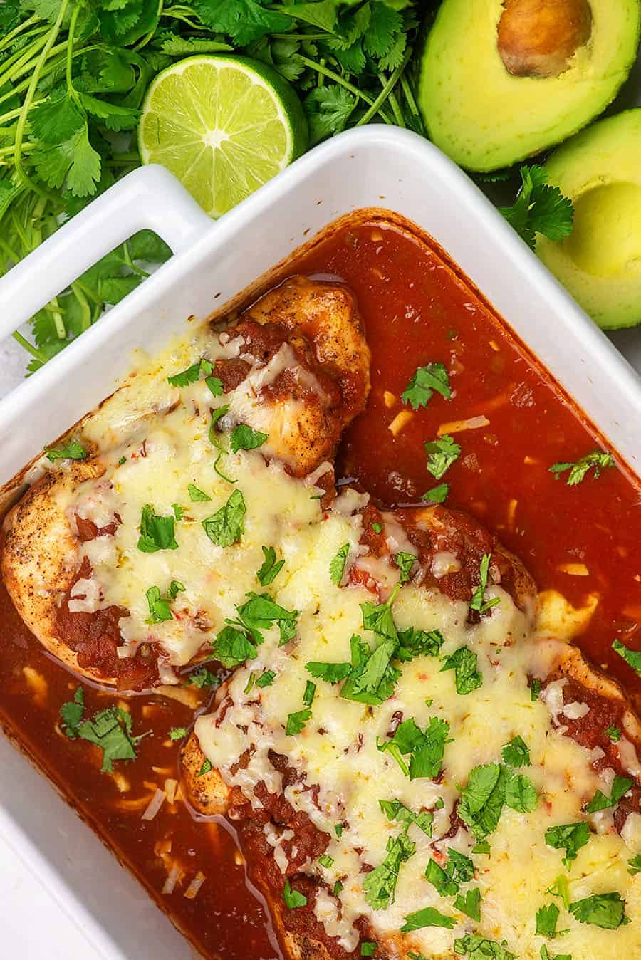 baked salsa chicken in white baking dish