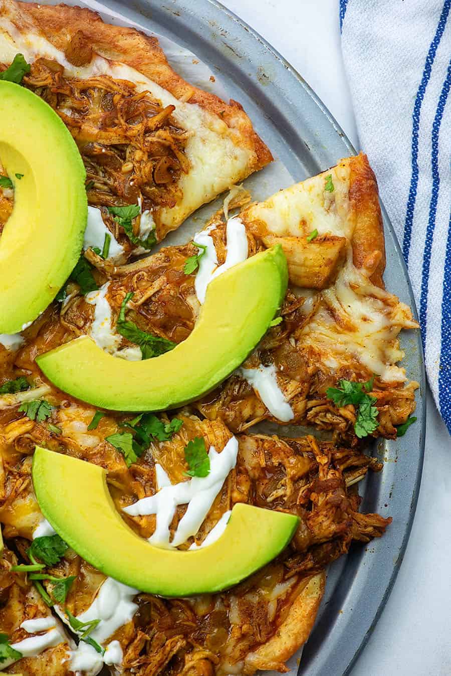 low carb chicken pizza cut into triangles on a pizza pan