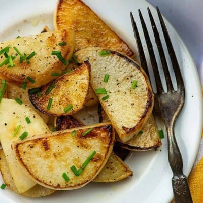 A plate of food with a fork, with Turnip