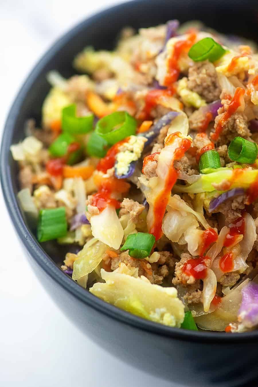 A close up of a bowl of egg roll filling