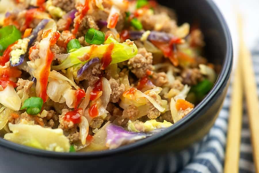 close up of egg roll filling in a black bowl