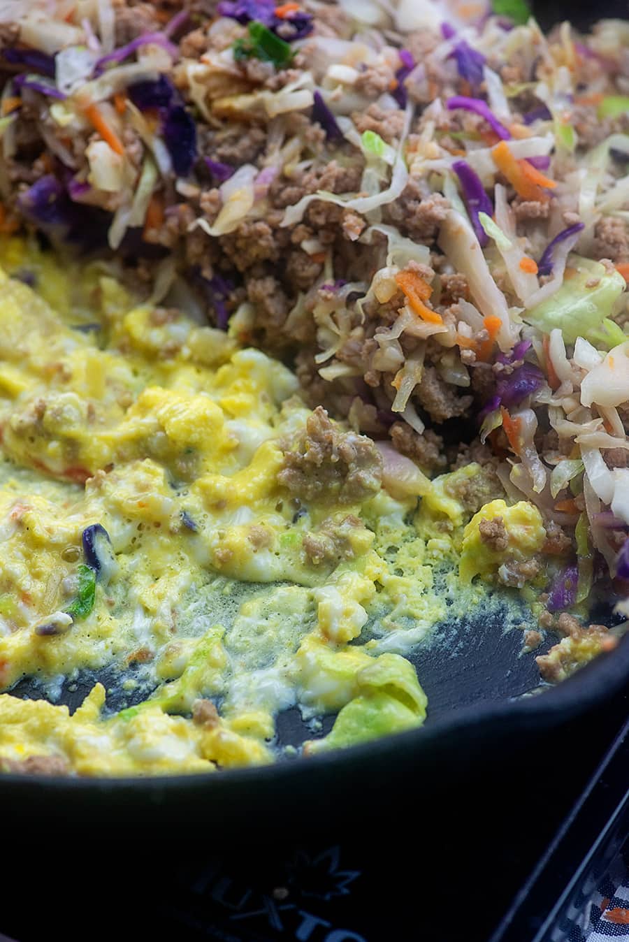 Eggs in skillet with coleslaw mix.