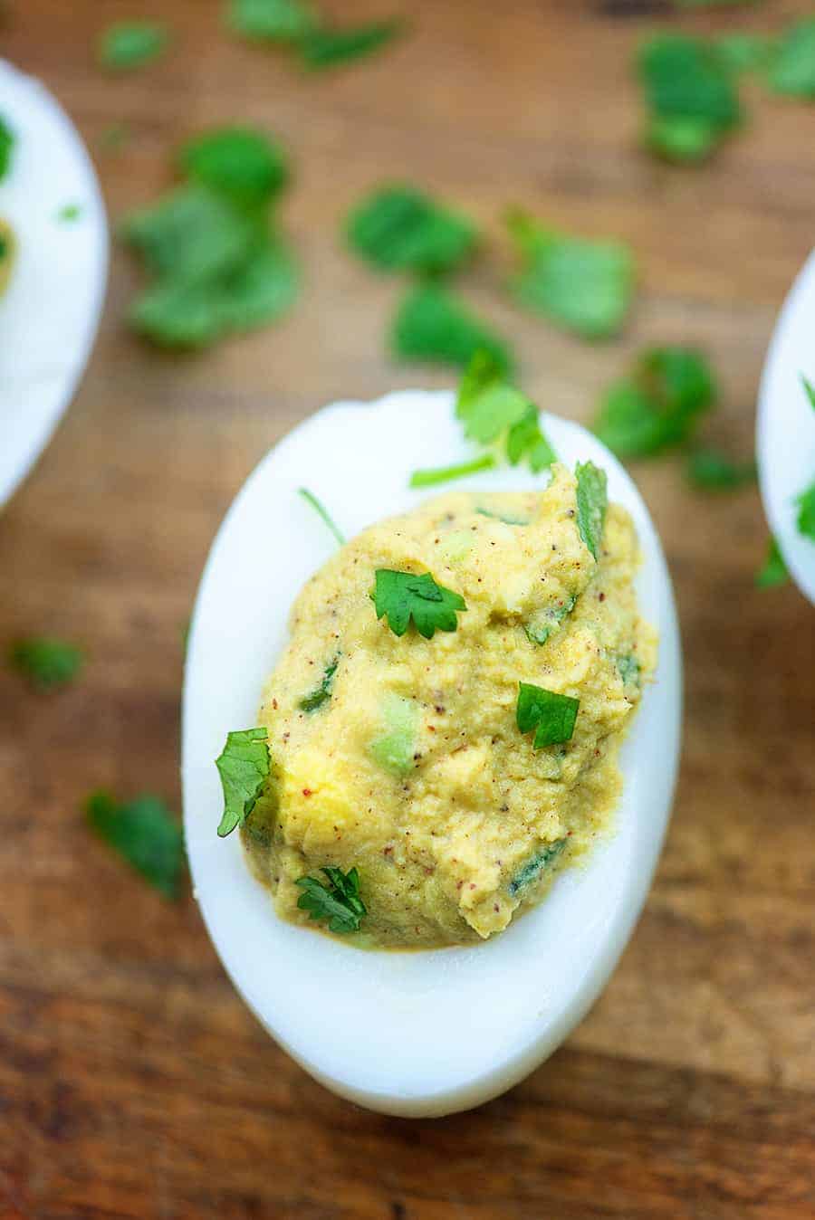 guacamole deviled eggs on cutting board