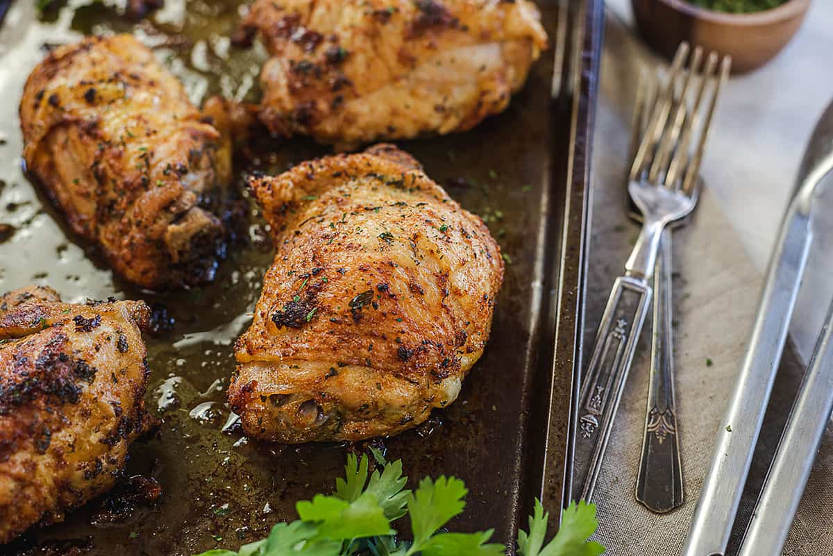 chicken thighs on baking sheet.