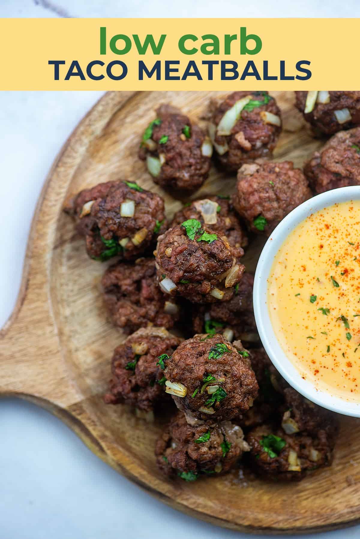 mexican meatballs with low carb queso on round wooden board