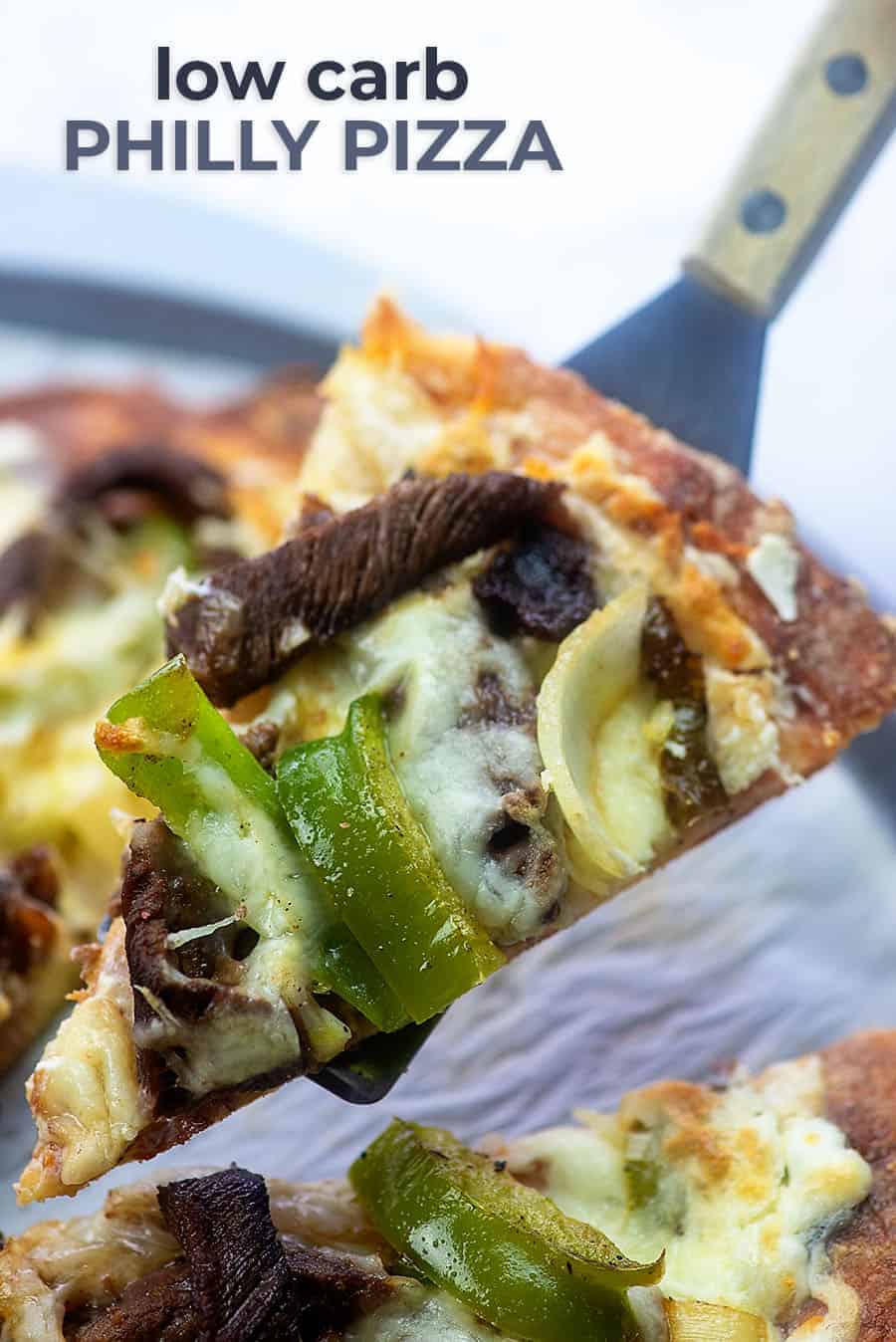 A single slice of cheesesteak pizza being held up to the camera.