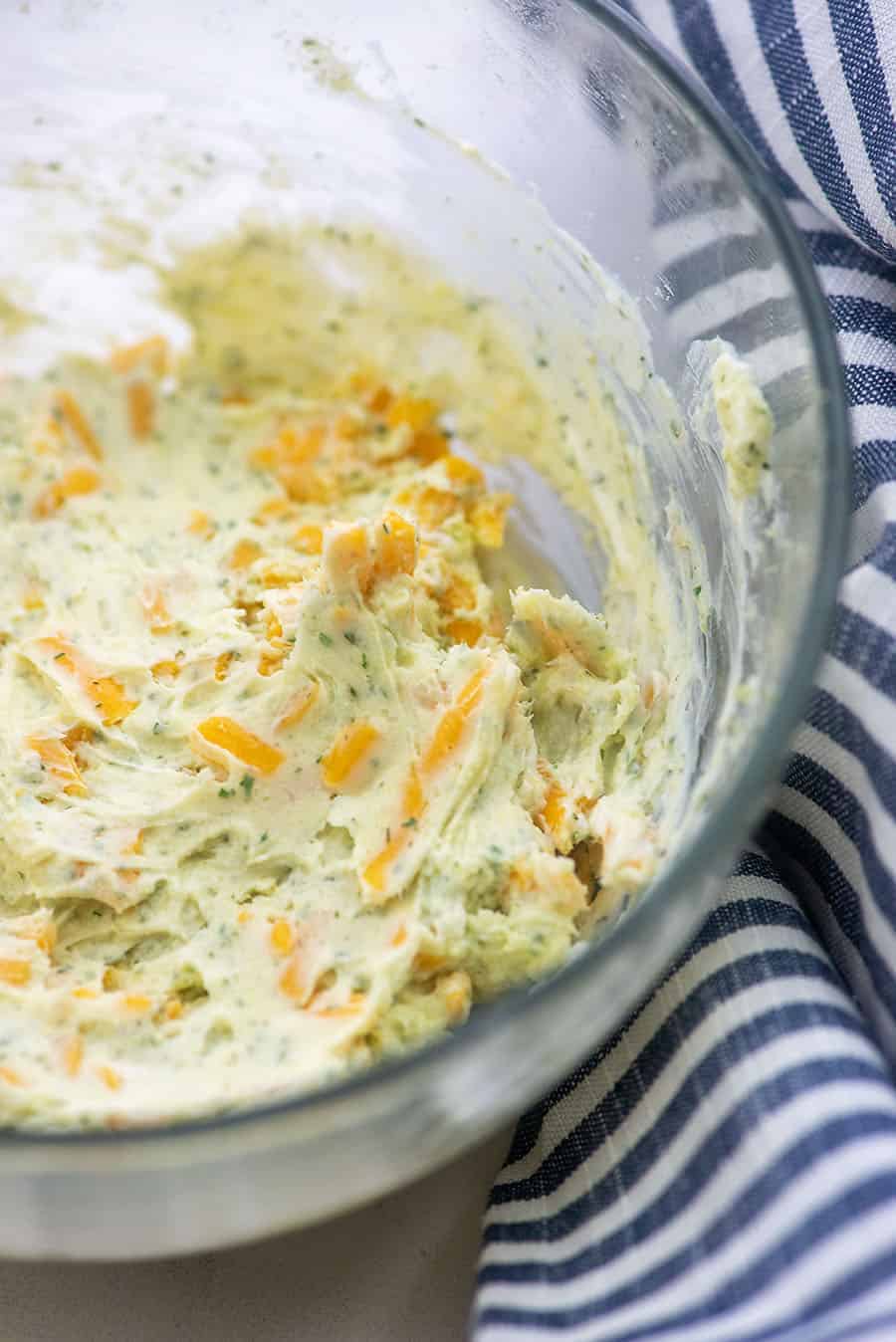 cream cheese filling for chicken breasts in a glass bowl