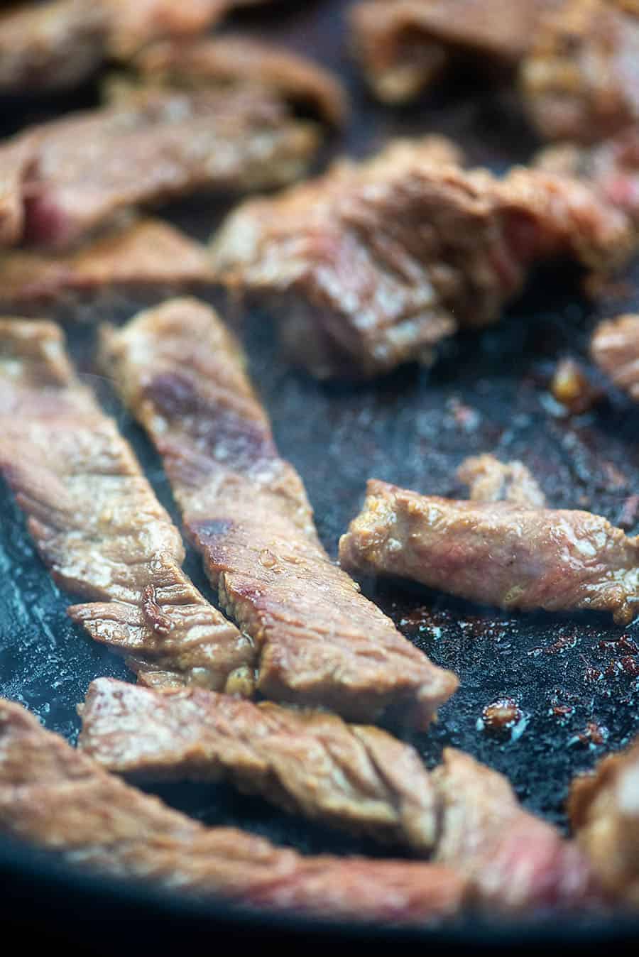 thin sliced steak in cast iron skillet