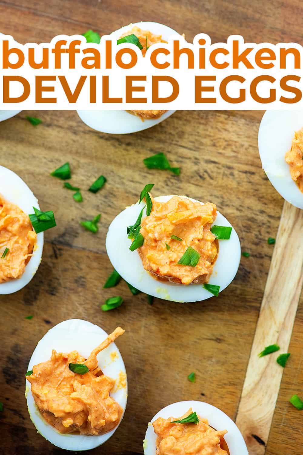 Several buffalo chicken deviled eggs on a wooden cutting board