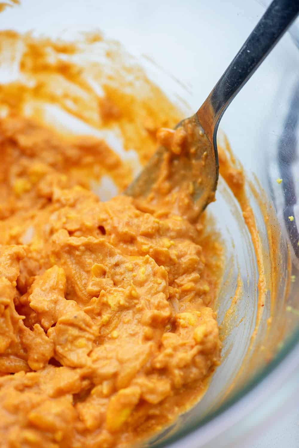 buffalo chicken mixture in glass bowl