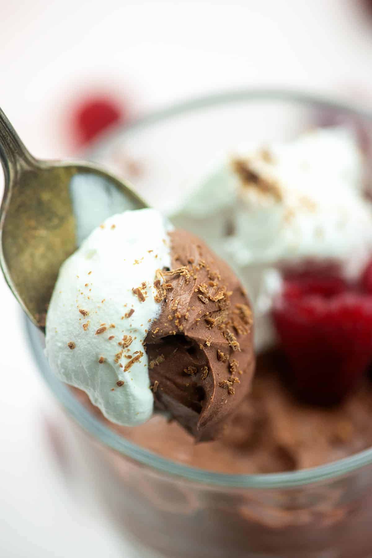 chocolate mousse and whipped cream on spoon