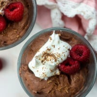 low carb chocolate mousse with whipped cream and raspberries