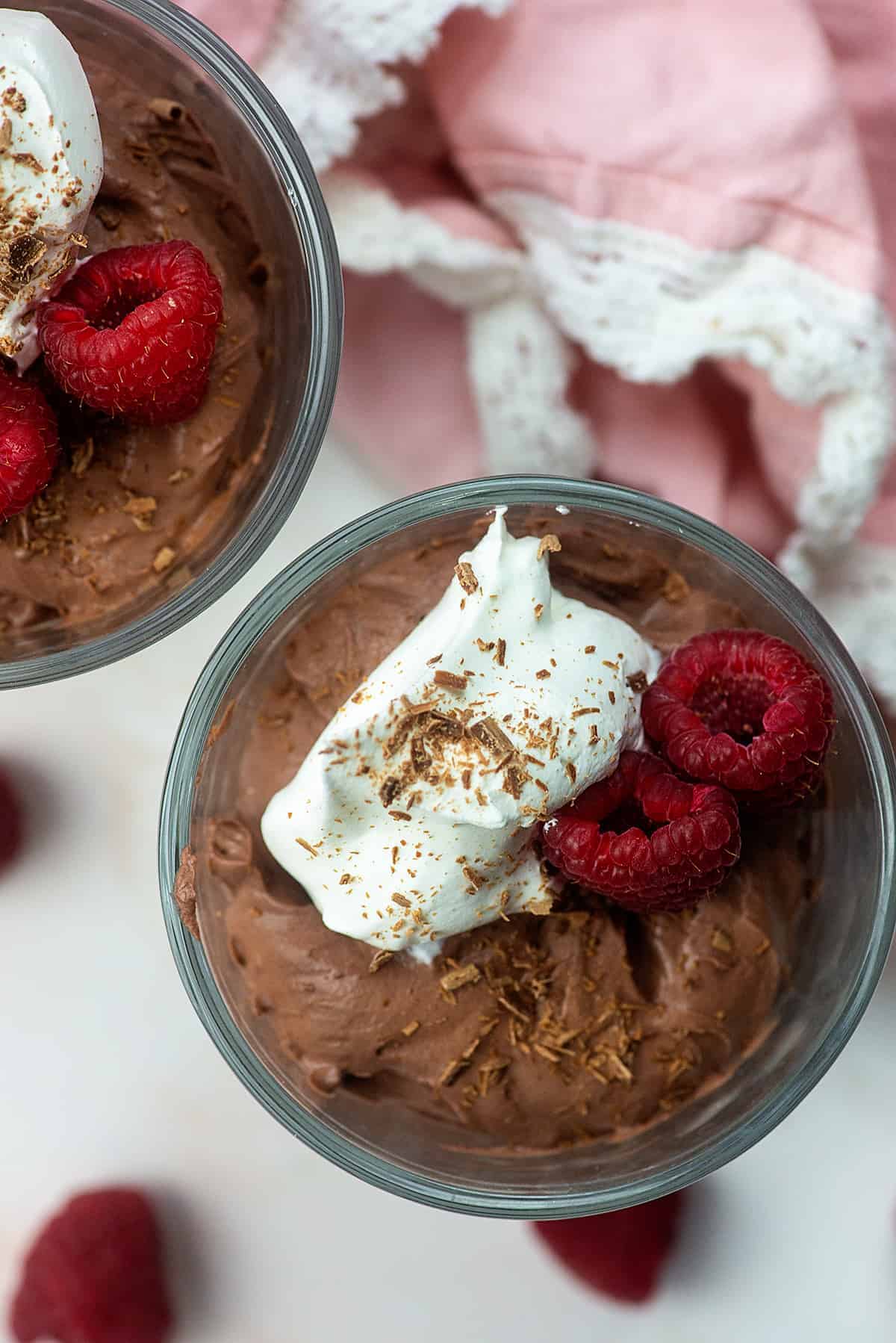 low carb chocolate mousse with whipped cream and raspberries