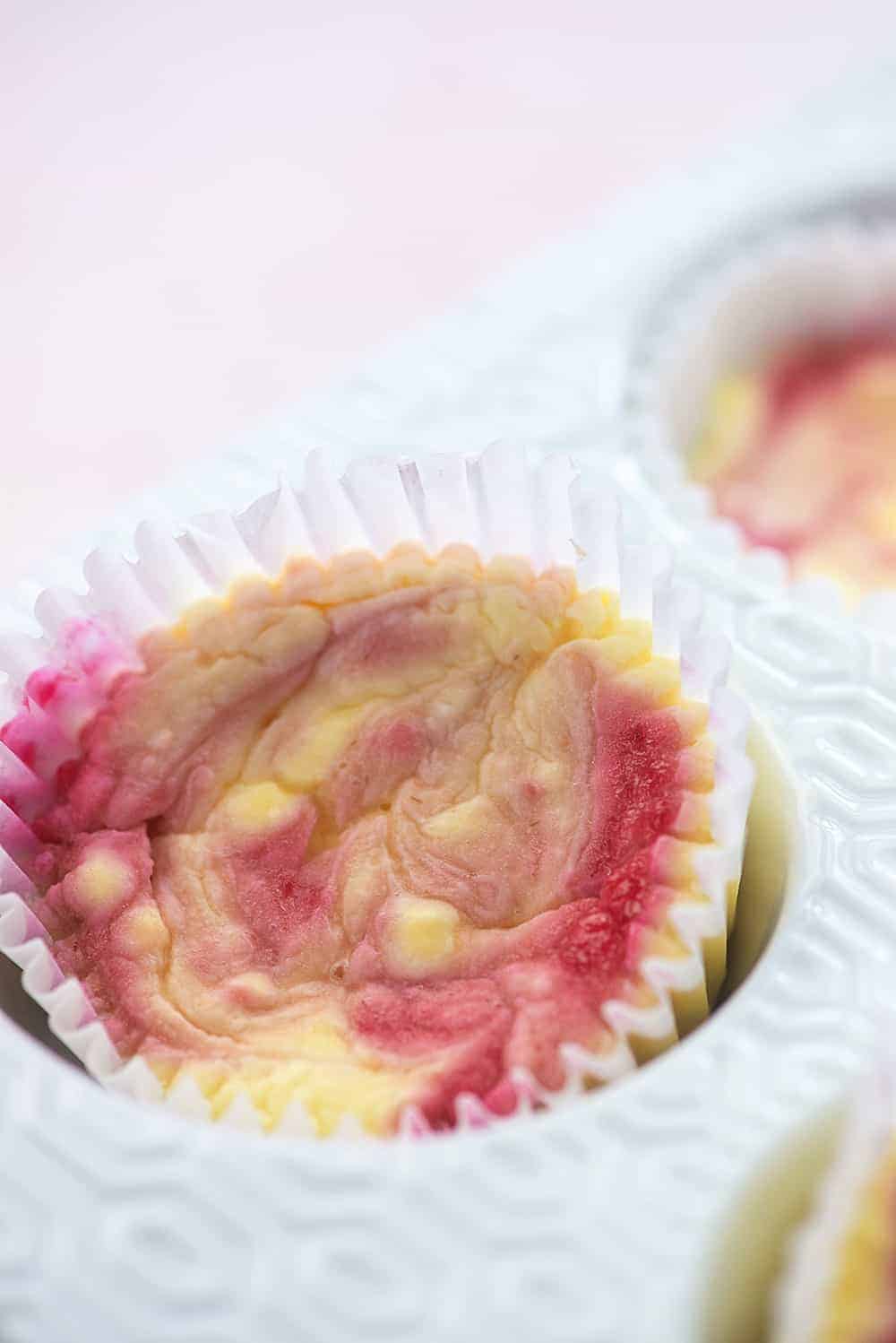 mini cheesecakes in white muffin tin