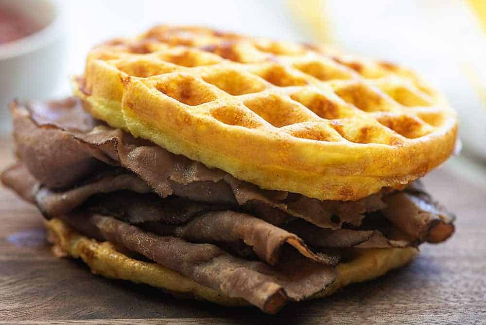 thin sliced roast beef on chaffle bun on a cutting board