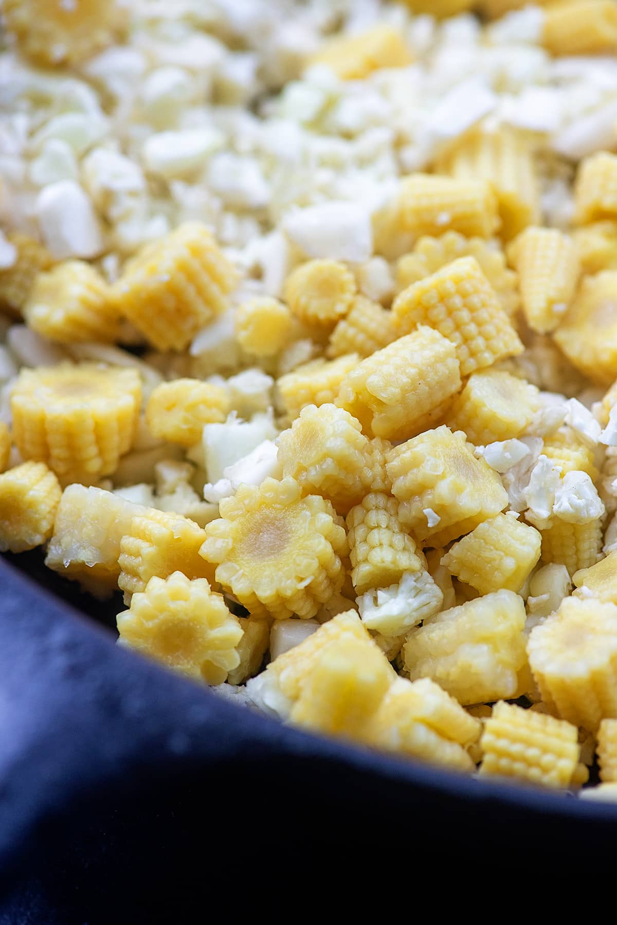 cauliflower and baby corn in cast iron skillet