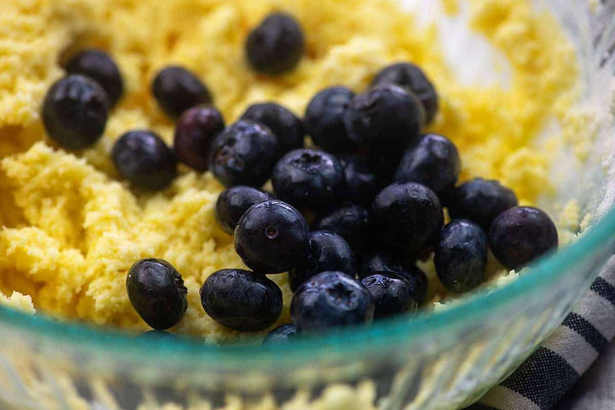 coconut flour cookie dough in glass bowl with blueberries