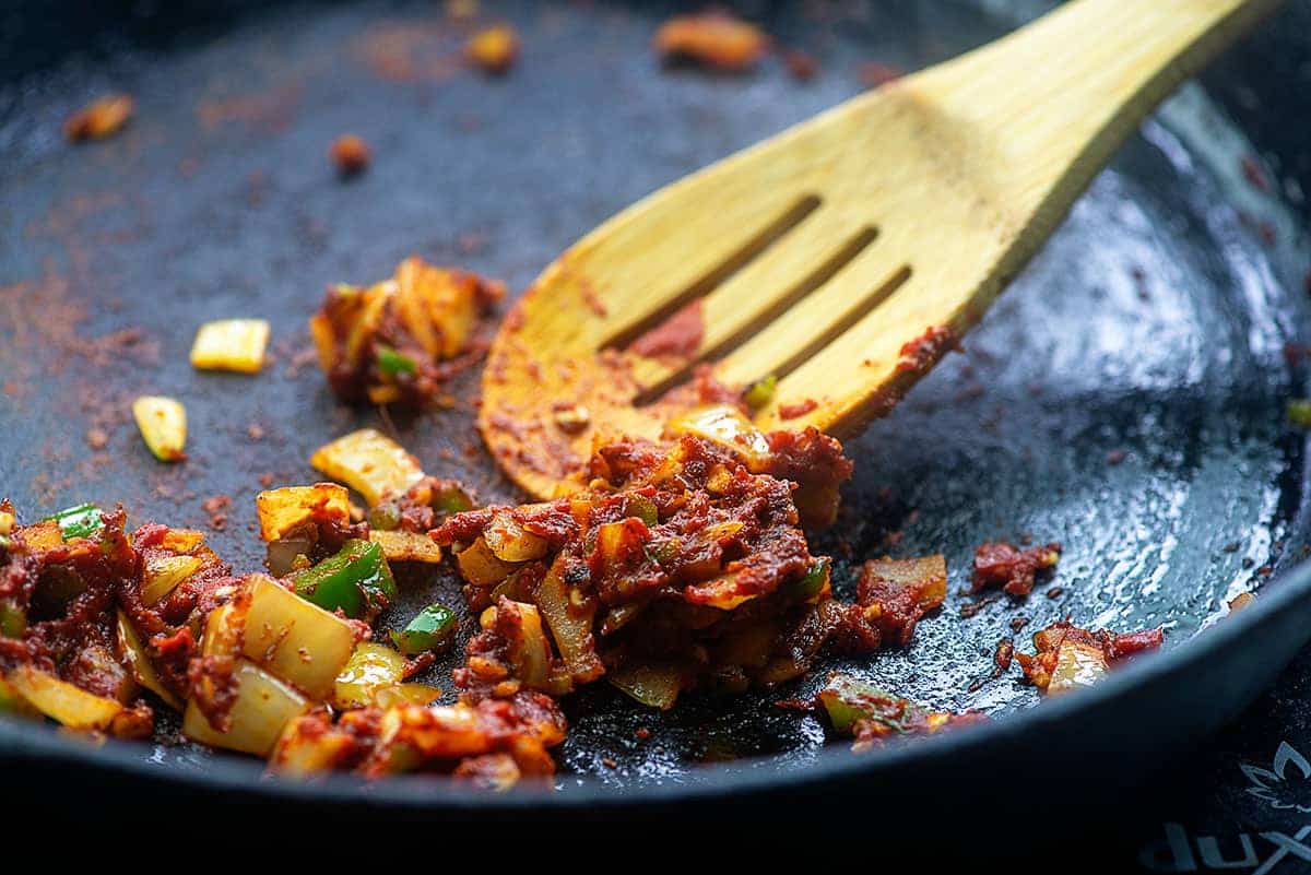 mexican cauliflower rice seasonings in cast iron skillet