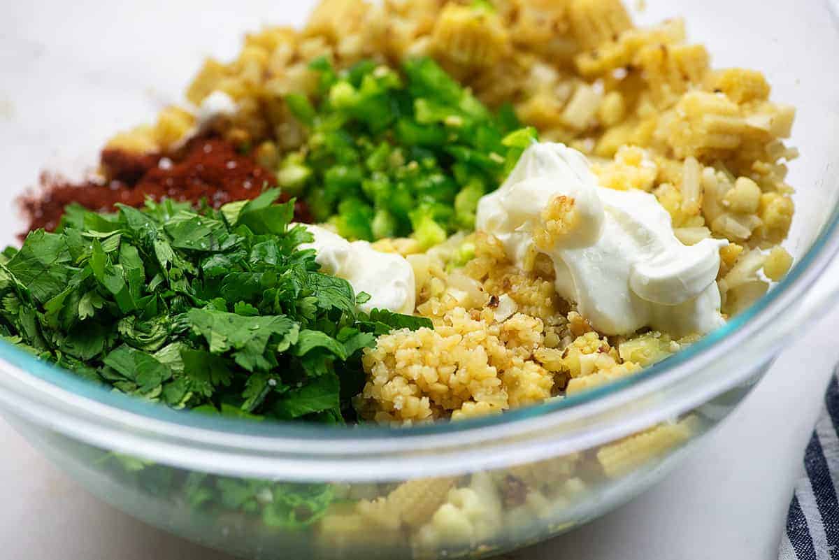 ingredients for low carb mexican street corn salad in glass mixing bowl