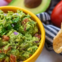 guacamole recipe with pork rinds in yellow bowl