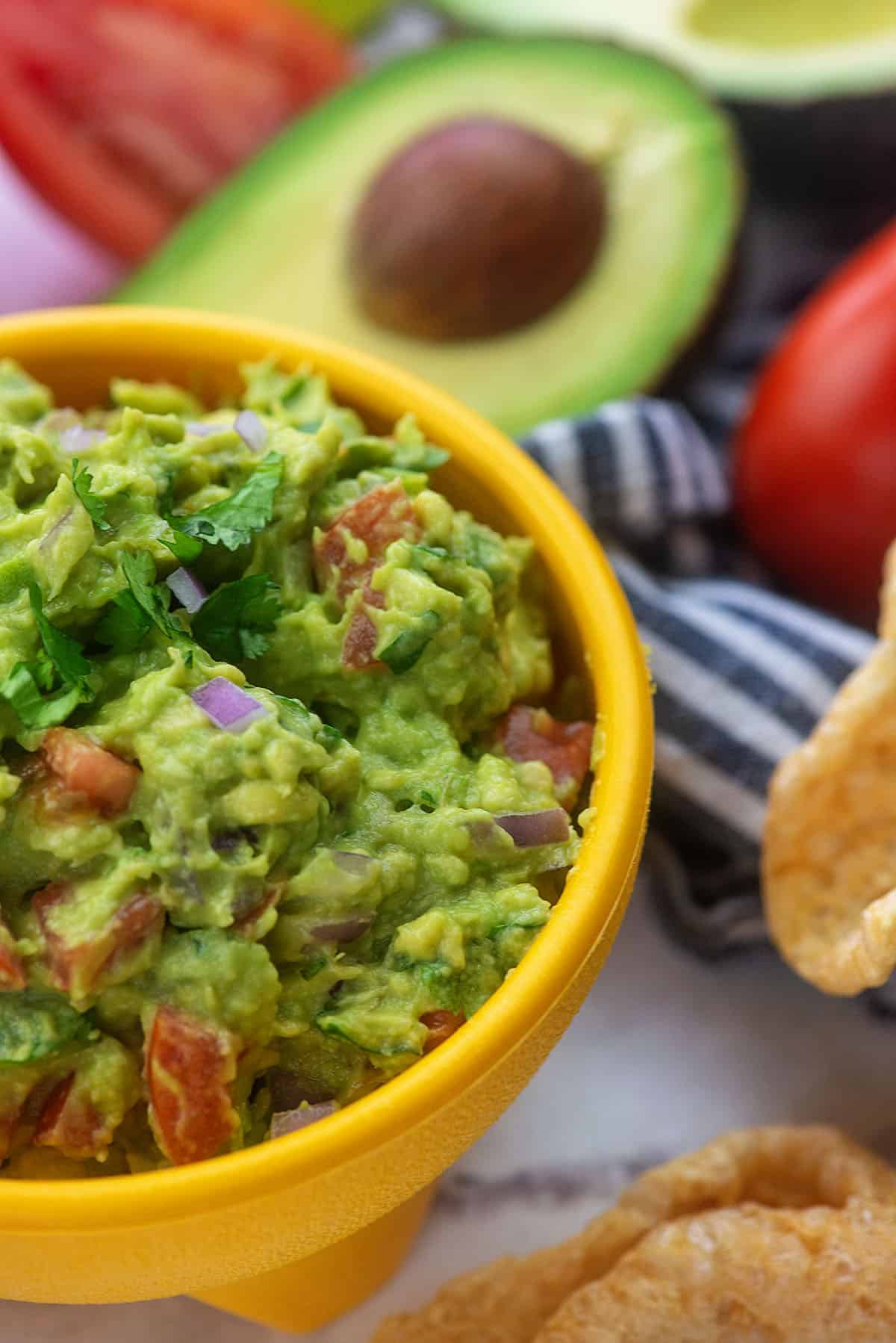 guacamole recipe with pork rinds in yellow bowl