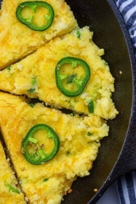 Overhead view of jalapeno cornbread cut into triangle pieces for serving.