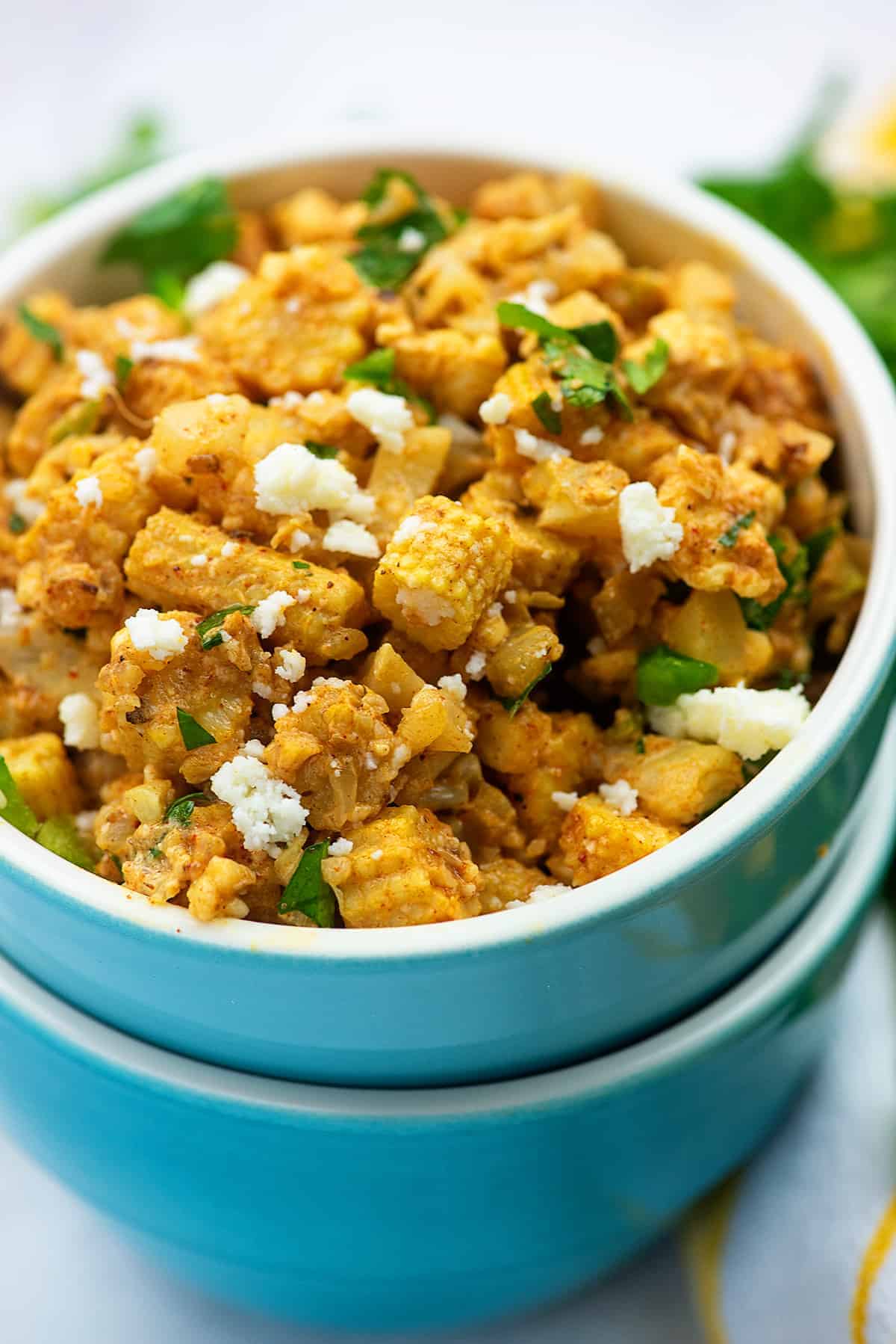 low carb elote salad in blue bowls