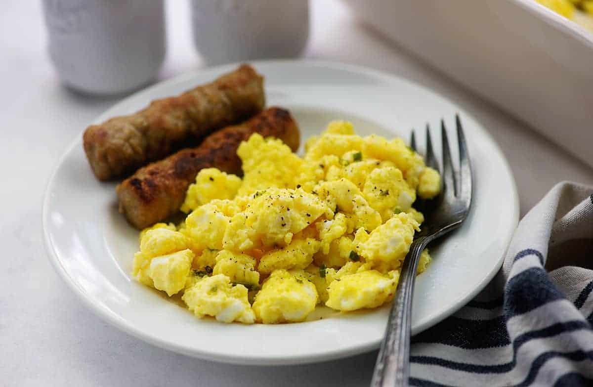 scrambled eggs on white plate with sausage links