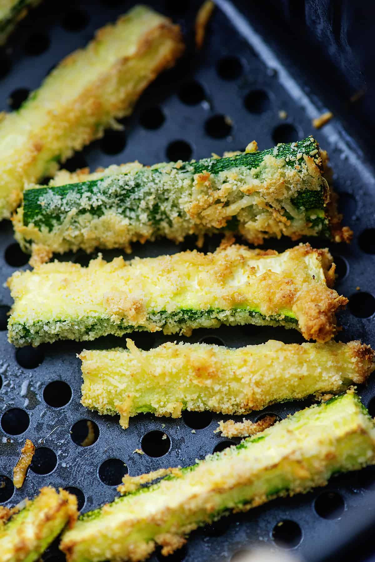 fried zucchini strips in air fryer basket