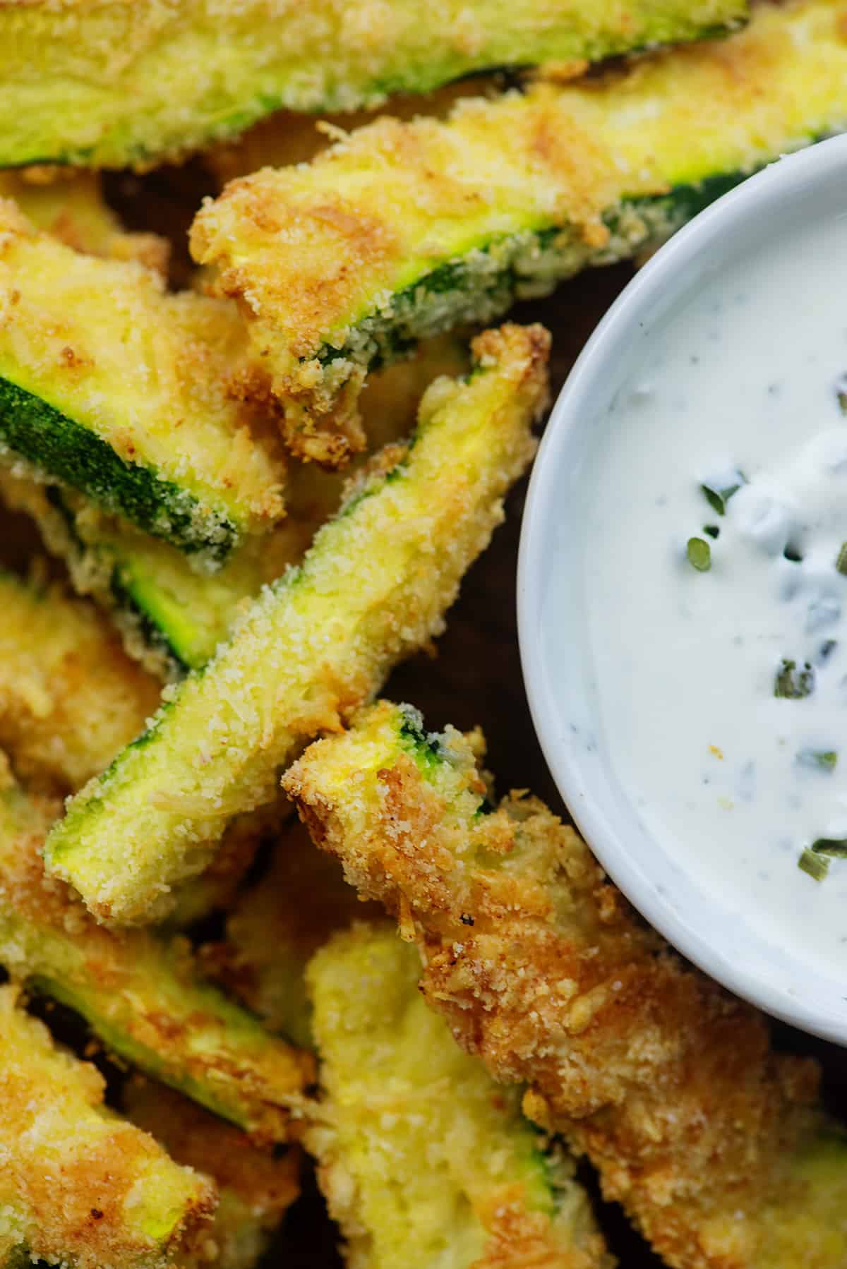 pile of zucchini fries surrounding dish of ranch dressing