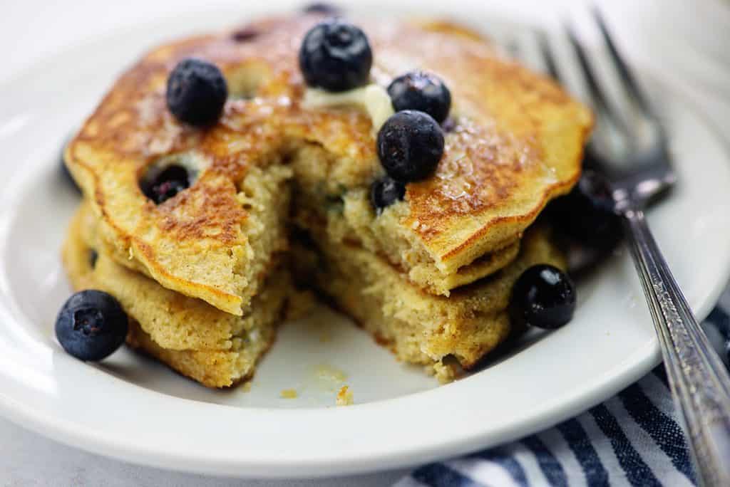 stack of cut pancakes with blueberries on top